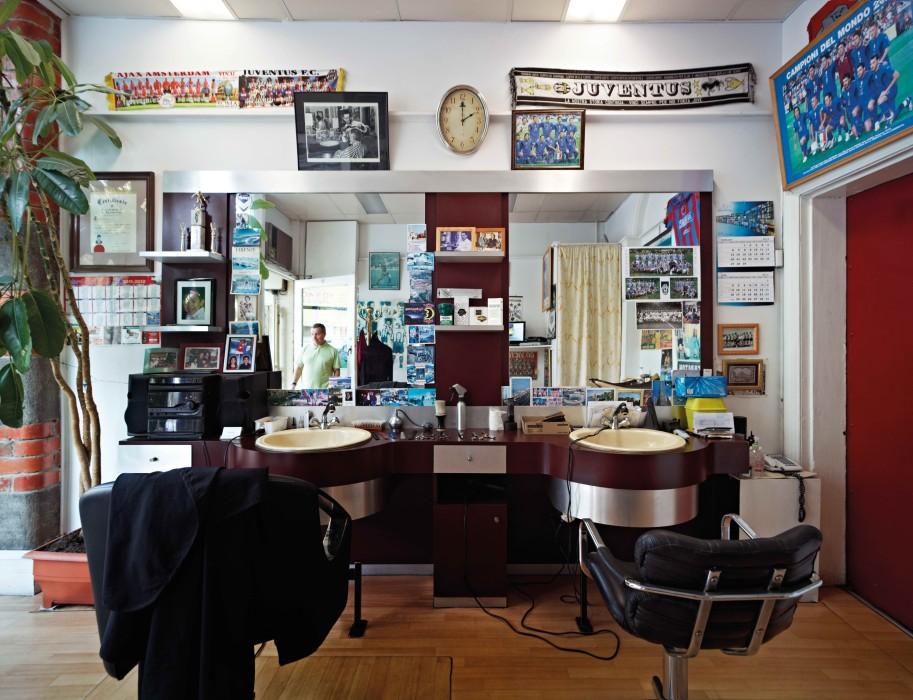 Barber store on lygon street with european football banners on wall