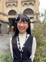 A person stands in front of Melbourne Town Hall.