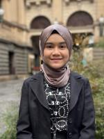 A person stands in front of Melbourne Town Hall.