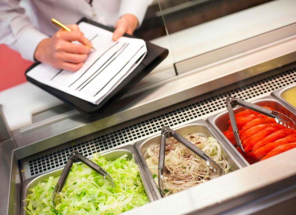 Food safety inspector inspecting food preparation