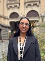 A person stands in front of Melbourne Town Hall.