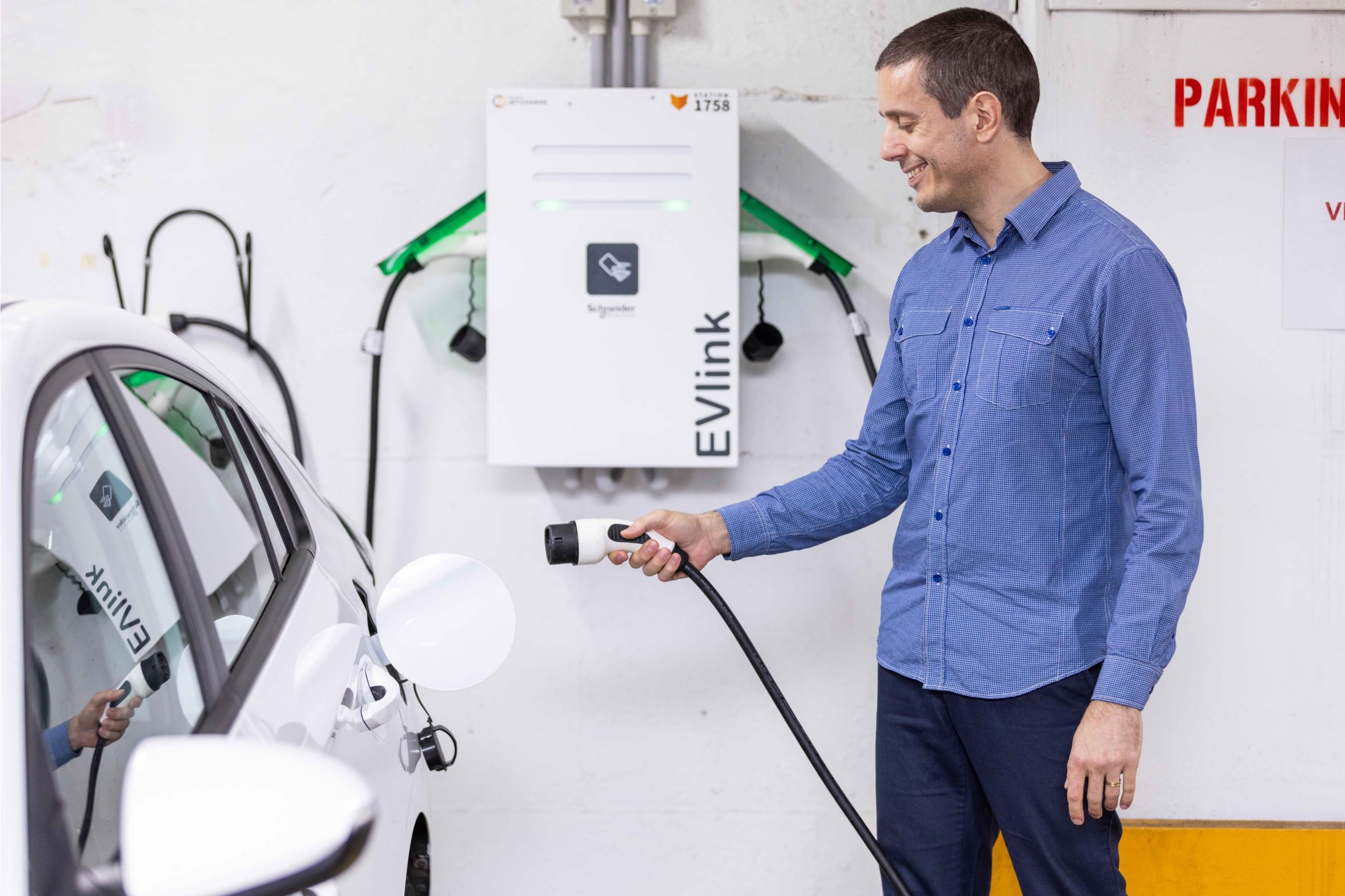 Person charging their electric car.