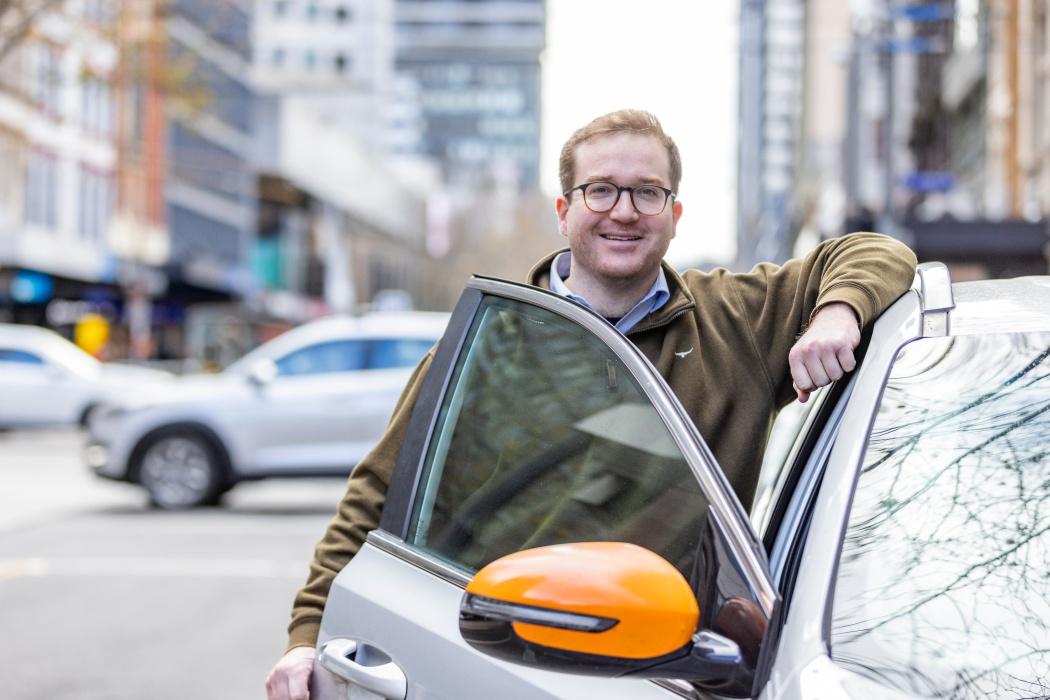 Man who just parked his car smiling at the world 