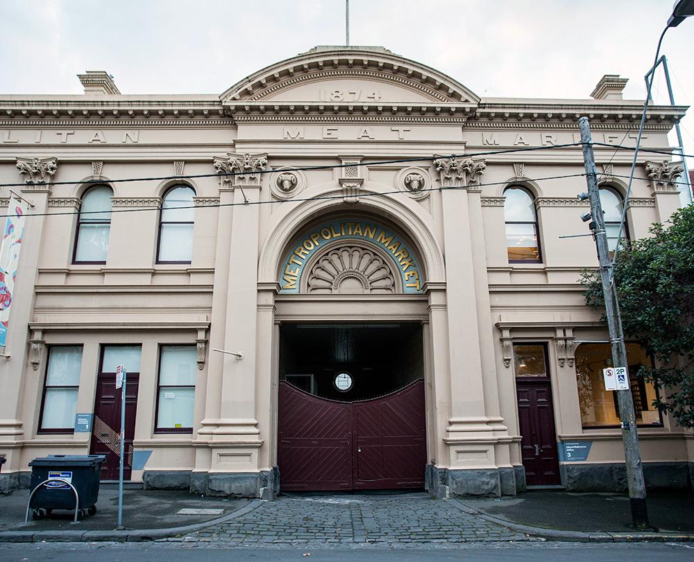 Heritage building with sign 'Metropolitan Market' above arched entranceway.