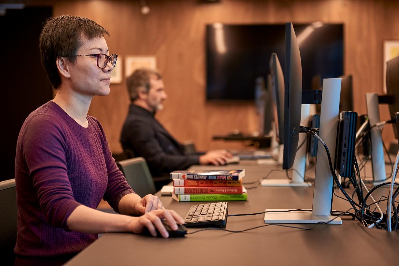 Person with glasses sitting at a computer.