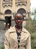 A person stands in front of Melbourne Town Hall.