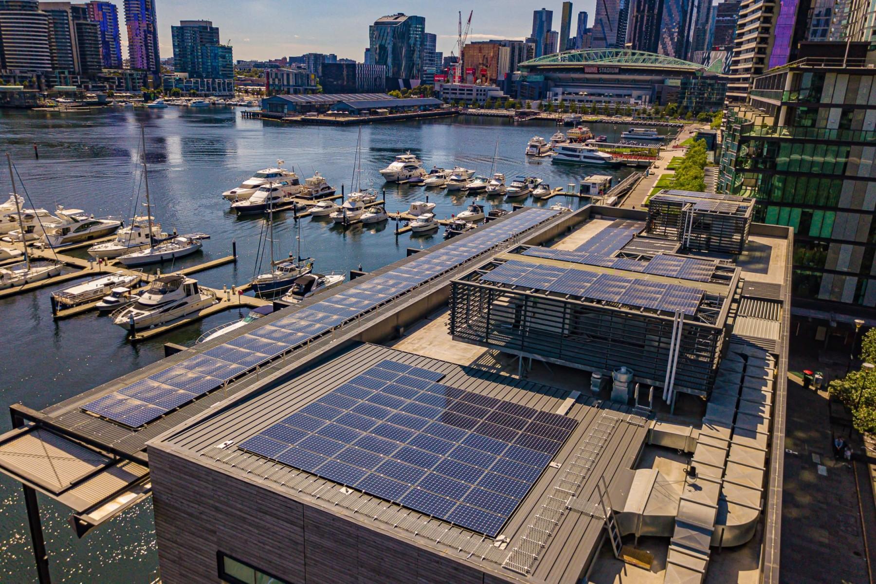 rooftop of solar panels with Yarra River and the city in the background