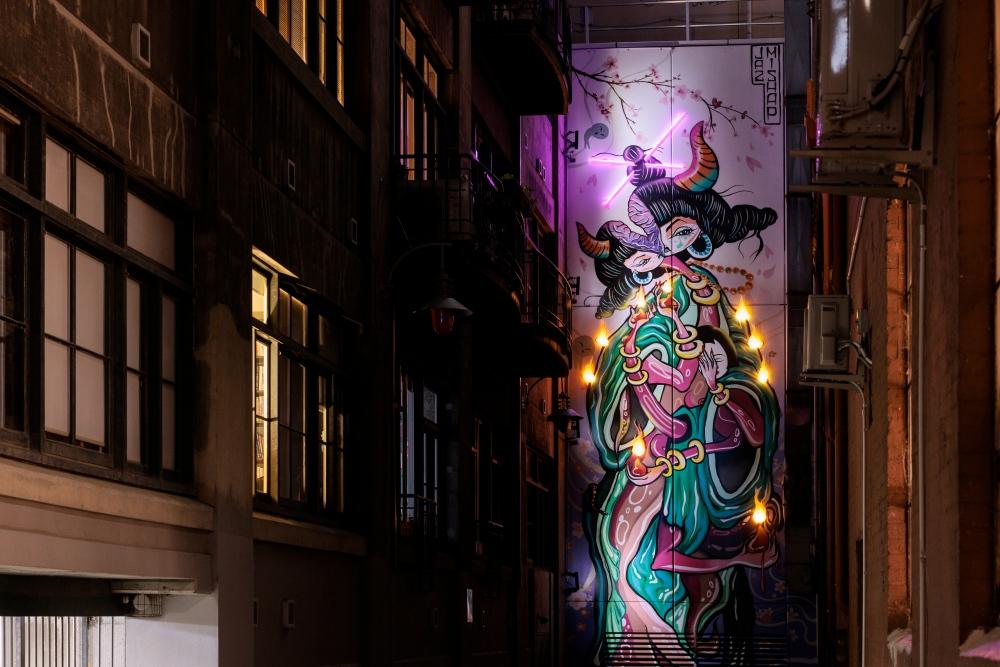Street art with lights in a laneway at night