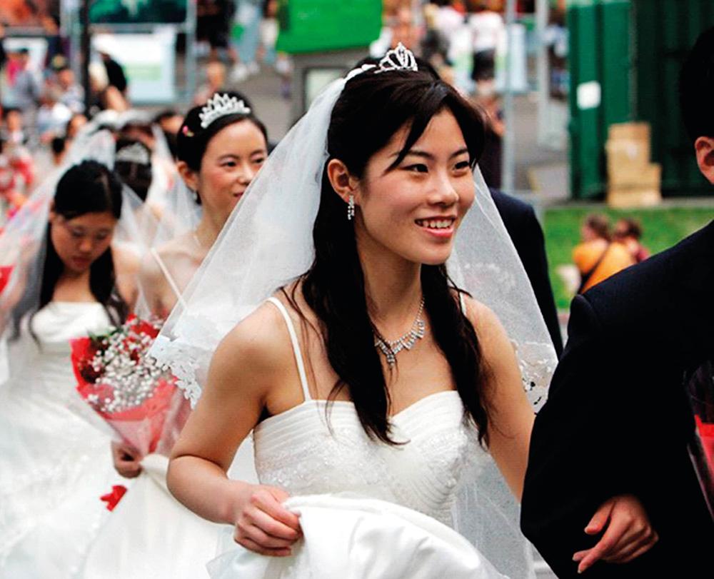 A woman in a wedding gown and veil. 